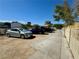 Wide driveway leading to a property with cars parked alongside a secure fence at 3895 Mountain Trl, Las Vegas, NV 89108