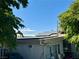 Exterior home view featuring solar panels on the roof, framed by mature trees against a clear blue sky at 3895 Mountain Trl, Las Vegas, NV 89108