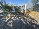 Charming garden area with small bridge, decorative rocks, and mature plants at 3895 Mountain Trl, Las Vegas, NV 89108