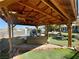 Covered gazebo with lounge seating and view of landscaped backyard at 3895 Mountain Trl, Las Vegas, NV 89108