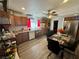 Functional kitchen area featuring wood cabinets, stainless steel appliances and a glass dining table at 3895 Mountain Trl, Las Vegas, NV 89108