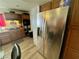 Kitchen area featuring wood cabinets, stainless steel appliances and view to oven and stovetop at 3895 Mountain Trl, Las Vegas, NV 89108