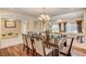 Formal dining room with hardwood floors, a chandelier, and views to living room at 4156 Balmoral Castle Ct, Las Vegas, NV 89141