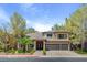 Beautiful two-story home with lush desert landscaping, a three-car garage, and a charming brick entryway at 4156 Balmoral Castle Ct, Las Vegas, NV 89141