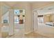 Hallway featuring access to the living room and main bedroom, with tile flooring and neutral paint at 4156 Balmoral Castle Ct, Las Vegas, NV 89141