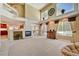 Sun-filled living room with a fireplace and views of the pool and outdoor area at 4156 Balmoral Castle Ct, Las Vegas, NV 89141