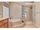 Elegant bathroom with a soaking tub, walk-in shower, and stylish finishes at 4156 Balmoral Castle Ct, Las Vegas, NV 89141