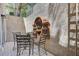 Outdoor patio showcasing a decorative fountain, dining set, and a cozy spot for relaxation at 4156 Balmoral Castle Ct, Las Vegas, NV 89141