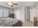 Bedroom features plush carpet, a ceiling fan, window with plantation shutters, closet, and dresser at 8351 Gold River Ct, Las Vegas, NV 89113