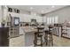 Bright modern kitchen with white cabinets, an island, and stainless steel appliances, tile floors at 8351 Gold River Ct, Las Vegas, NV 89113