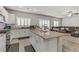 Modern kitchen with a large granite island, white cabinets, stainless steel appliances and tile floors at 8351 Gold River Ct, Las Vegas, NV 89113