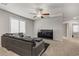 Large living room with plush sofa and a sleek ceiling fan at 8351 Gold River Ct, Las Vegas, NV 89113