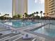 Resort-style pool with multiple hot tubs, lounge chairs, and palm trees at 145 E Harmon Ave # 1120, Las Vegas, NV 89109