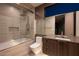 Modern bathroom with glass shower, tub, and sleek vanity at 12 Chisel Crest Ct, Henderson, NV 89012