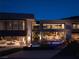 Modern luxury home with a stunning pool illuminated at night at 12 Chisel Crest Ct, Henderson, NV 89012