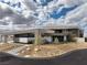 Modern home showcasing minimalist architecture, a desert landscape, and an inviting front entrance at 12 Chisel Crest Ct, Henderson, NV 89012