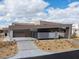 Modern home with multi-car garage, minimalist design, desert landscaping, and a welcoming front entrance at 12 Chisel Crest Ct, Henderson, NV 89012