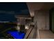 Balcony view showcases a sleek pool and city skyline at night at 12 Chisel Crest Ct, Henderson, NV 89012