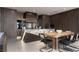 Modern kitchen with stainless steel appliances, marble island, and adjacent dining area at 12 Chisel Crest Ct, Henderson, NV 89012