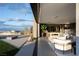 Open living room with seamless indoor-outdoor flow, featuring modern furniture and landscape views at 12 Chisel Crest Ct, Henderson, NV 89012