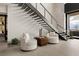 Cozy sitting area under a modern staircase with contemporary chairs and sleek design elements at 12 Chisel Crest Ct, Henderson, NV 89012