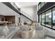 Open-concept living room features a modern staircase and expansive windows with outdoor views at 12 Chisel Crest Ct, Henderson, NV 89012