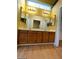 Double vanity bathroom with wood cabinets and a large mirror at 2802 Camelback Ln, Henderson, NV 89074