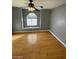 Well-lit bedroom, featuring hardwood floors and an arched window at 2802 Camelback Ln, Henderson, NV 89074