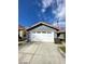 Two-car garage with white door and driveway at 2802 Camelback Ln, Henderson, NV 89074