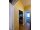 A hallway with wood floors and doors to bedrooms and bathroom at 2802 Camelback Ln, Henderson, NV 89074