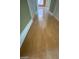 Clean hallway with light colored hardwood floors at 2802 Camelback Ln, Henderson, NV 89074