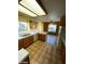 Kitchen with island, wood cabinets, and view to pool at 2802 Camelback Ln, Henderson, NV 89074