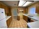 View of kitchen with wood cabinets and tiled floor at 2802 Camelback Ln, Henderson, NV 89074