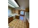 Kitchen features wood cabinets, island, and tiled floor at 2802 Camelback Ln, Henderson, NV 89074