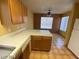 Kitchen with island, wood cabinets, and tiled floor at 2802 Camelback Ln, Henderson, NV 89074