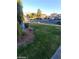 Landscaped yard with green grass and plants at 2802 Camelback Ln, Henderson, NV 89074