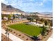 Expansive green lawn and shaded seating area within a picturesque community setting at 681 Echelon St, Las Vegas, NV 89138