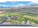 Expansive aerial view of the community park with a playground and soccer fields, set against a backdrop of mountains at 12295 Skyracer Dr, Las Vegas, NV 89138