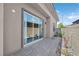 Modern outdoor patio featuring stone pavers, desert landscaping, and sliding glass door at 12295 Skyracer Dr, Las Vegas, NV 89138