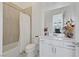 Clean bathroom with a bathtub, white vanity, and beige tile at 12295 Skyracer Dr, Las Vegas, NV 89138