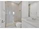 Modern bathroom featuring a glass shower with gray tiling, a white vanity, and neutral color palette at 12295 Skyracer Dr, Las Vegas, NV 89138