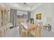 Bright dining room featuring a wood table and access to the backyard at 12295 Skyracer Dr, Las Vegas, NV 89138