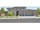 Single-story home with a two-car garage and landscaped front yard at 12295 Skyracer Dr, Las Vegas, NV 89138