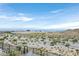 Desert landscape with low-lying vegetation, fence and mountain views, showcasing the natural terrain at 12295 Skyracer Dr, Las Vegas, NV 89138