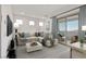 Stylish living room showcasing a sectional sofa, a sliding glass door to a patio, and modern decor at 12295 Skyracer Dr, Las Vegas, NV 89138