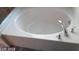 Close-up of a pristine white bathtub with modern fixtures at 4085 Oliver Sagebrush Dr, Las Vegas, NV 89122