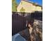View of a backyard with a newly installed brown fence and desert landscaping at 2881 Thunder Bay Ave, Henderson, NV 89052