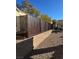 View of a backyard with a newly installed brown fence and desert landscaping at 2881 Thunder Bay Ave, Henderson, NV 89052