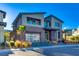 Contemporary home with stone accents and a three-car garage at 10632 Patina Hills Ct, Las Vegas, NV 89135