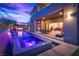 Luxury pool and spa with waterfall feature at dusk at 10632 Patina Hills Ct, Las Vegas, NV 89135